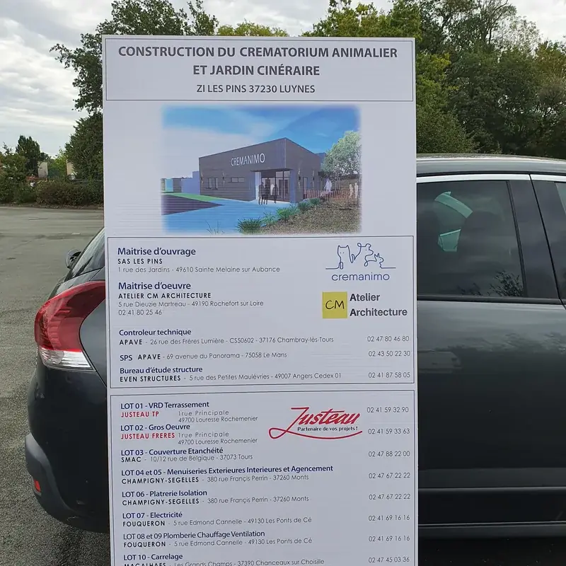 Panneau de chantier de la construction d’un crématorium animalier, avec la liste des lots et des entreprises