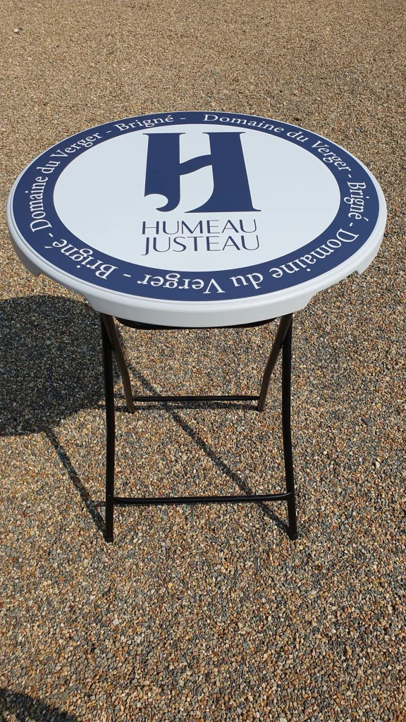 Mange-debout pliant au plateau bleu marine et blanc, logo H Humeau Justeau, Domaine du Verger